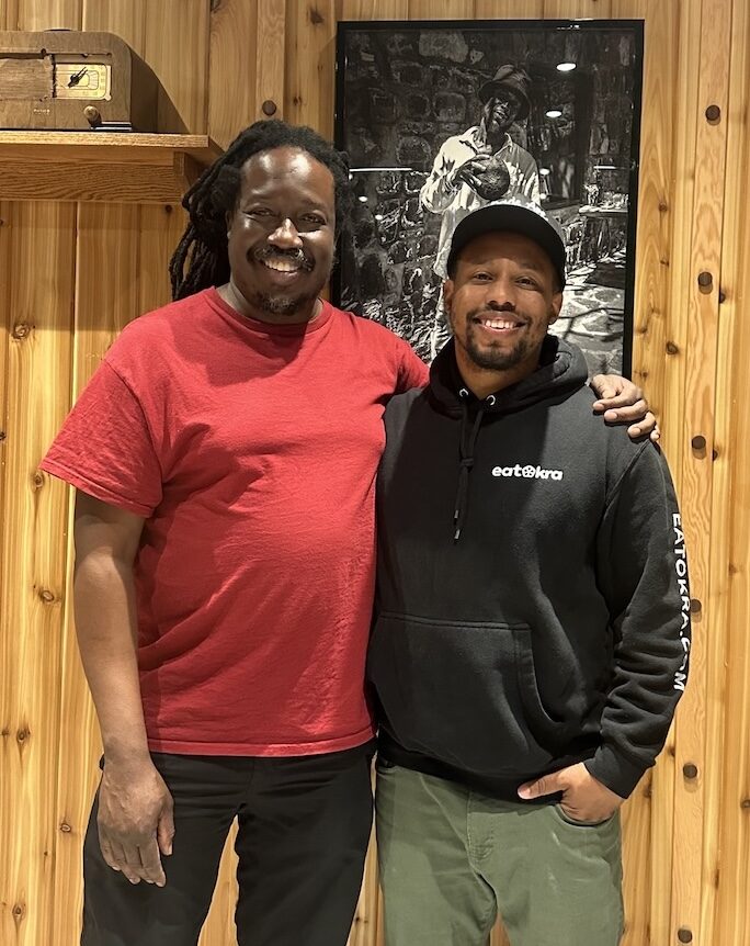 Two guests smiling together at an EatOkra event